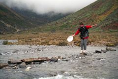 26 Shane Teeters Across The Rocks And Logs In The River Almost To Camp At Joksam Tibet